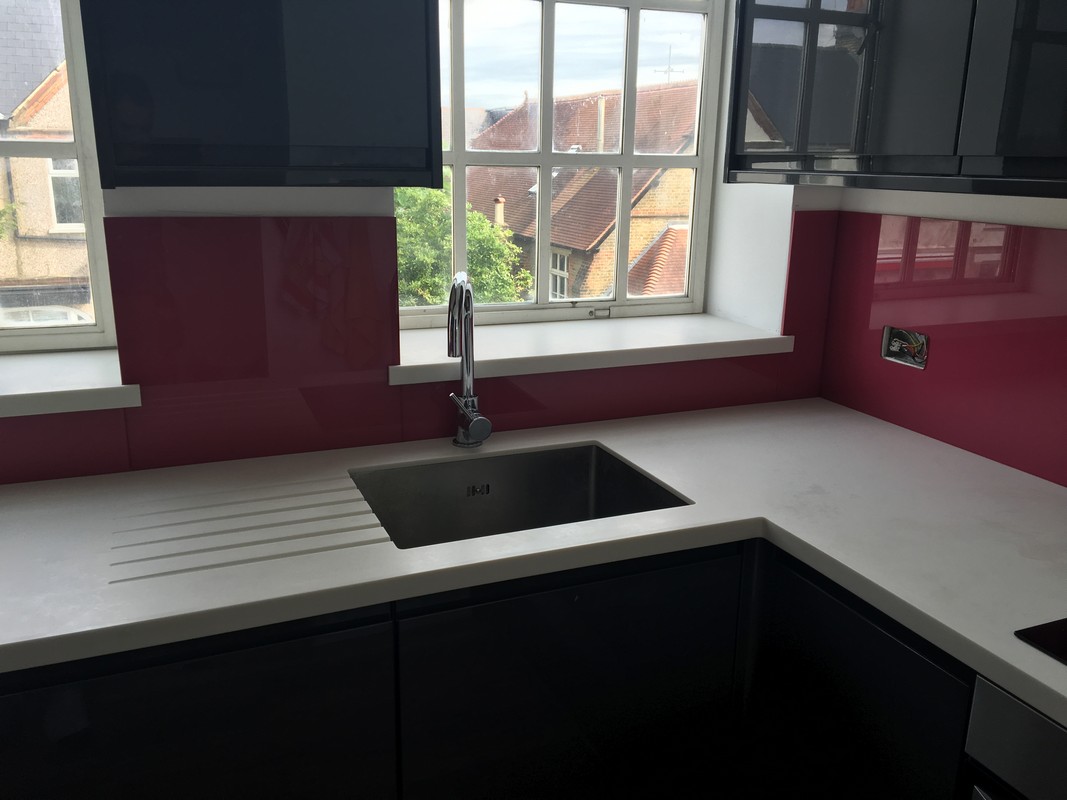 Deep plum coloured glass splashback in modern Brent Cross kitchen